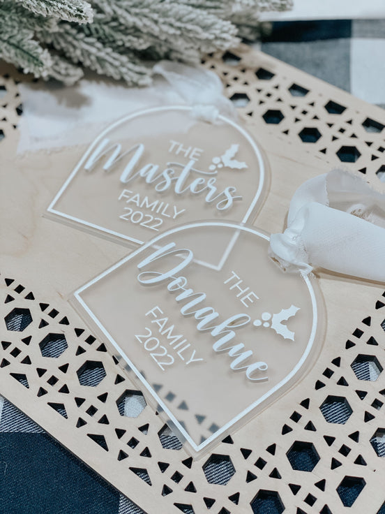Clear arched family ornaments with raised white Masters and Pantano lettering and engraved years.