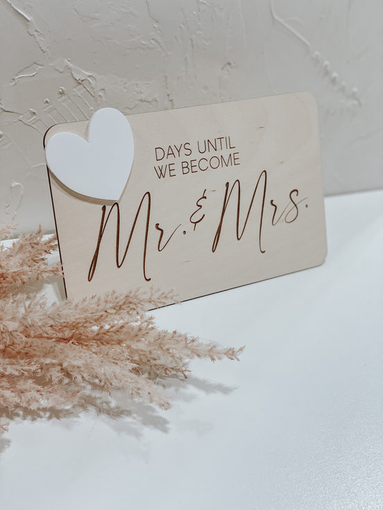 Wooden Days Until We Become Mr. and Mrs. countdown sign with a white writable heart.