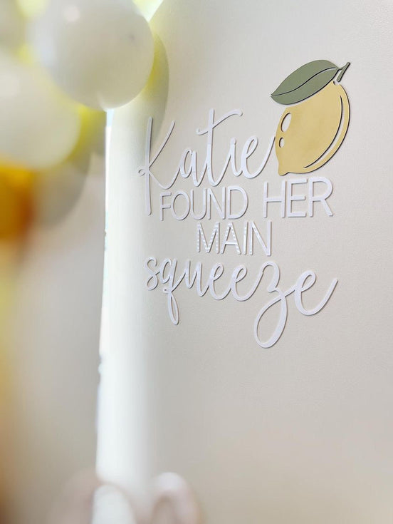 Katie Found Her Main Squeeze bridal-shower lettering with a lemon accent on a pale backdrop.