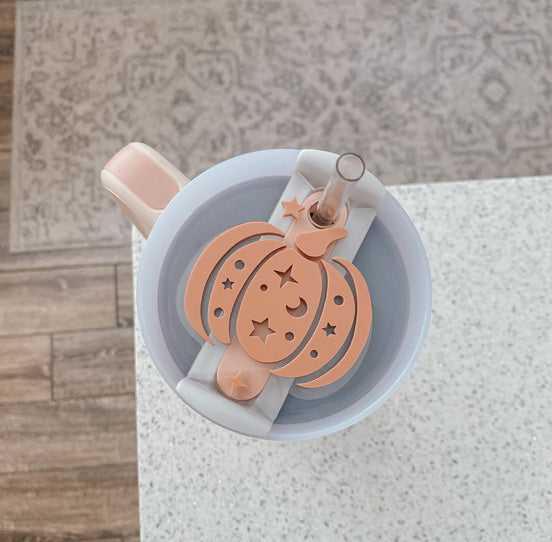 Terra-cotta pumpkin tumbler topper with a moon, stars and a pale bow.