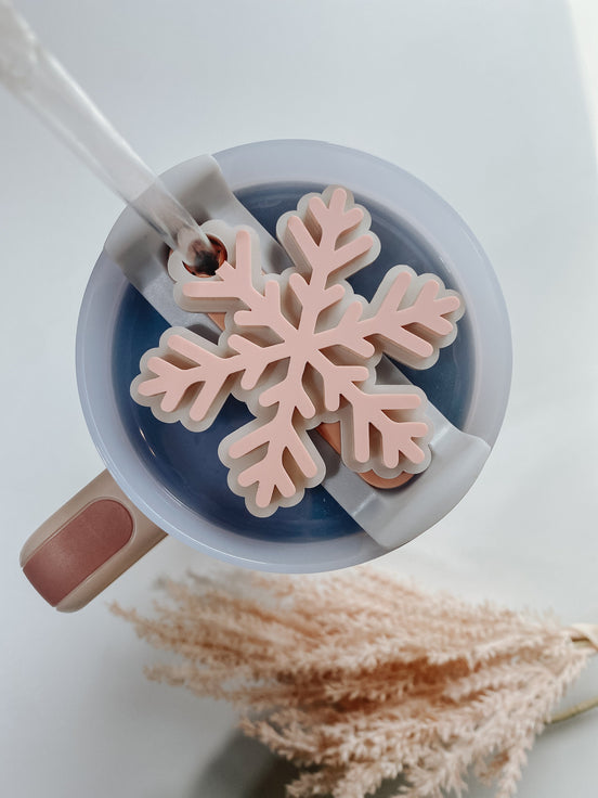 Unpersonalized pink snowflake topper fitted around a clear tumbler straw.