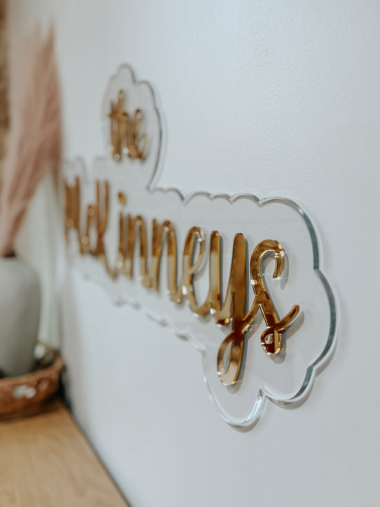 Side view of The McKinneys sign showing raised mirrored lettering on a clear acrylic outline.