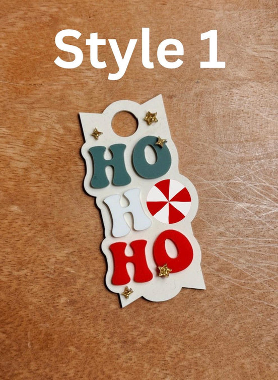 Style 1 holiday topper with stacked Ho Ho Ho lettering, peppermint detail and star accents.