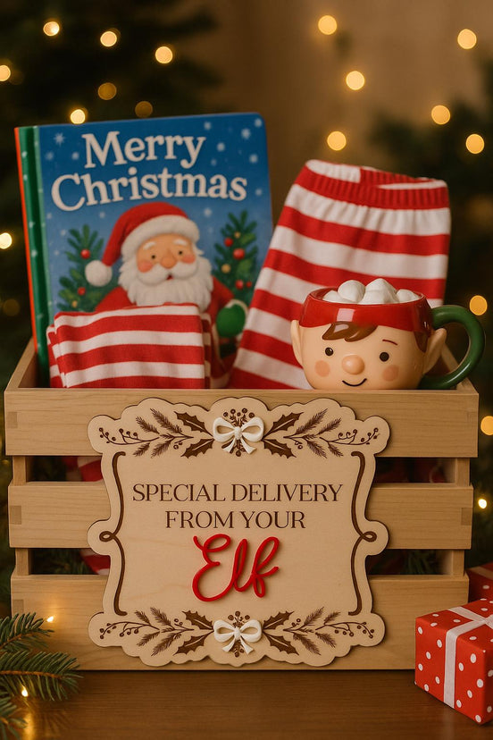 Special Delivery From Your Elf plaque on a Christmas crate filled with a book and festive mug.