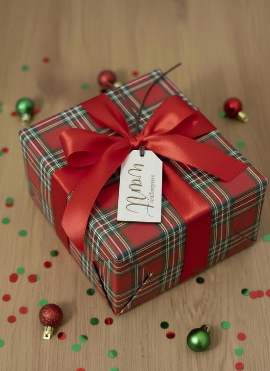 Wooden Want gift tag tied to a red plaid present with a red bow.