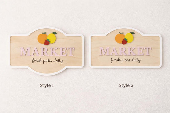Two wooden Market sign styles with pink lettering and raised fruit accents shown side by side.