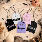 Personalized ghost tags in black, pink, white and purple with twisted cords and Halloween decorations.