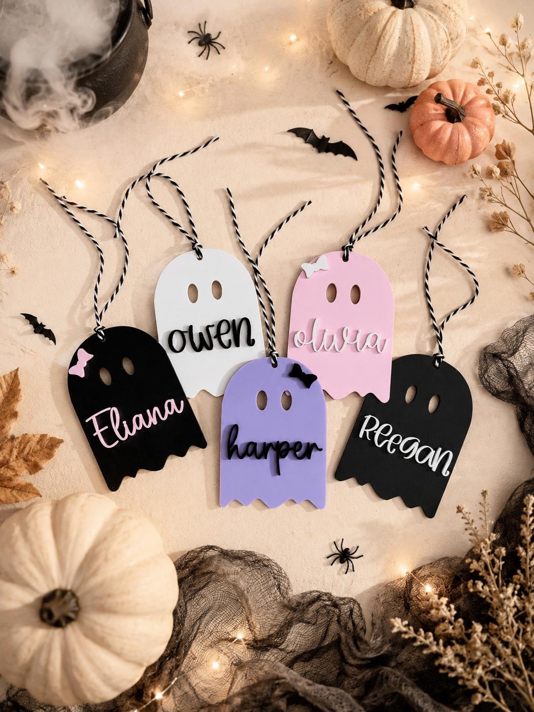 Personalized ghost tags in black, pink, white and purple with twisted cords and Halloween decorations.